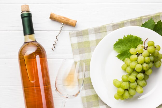 Grapes on plate and white wine