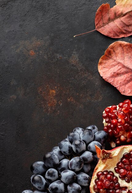 Grapes and pomegranate autumn fruit copy space