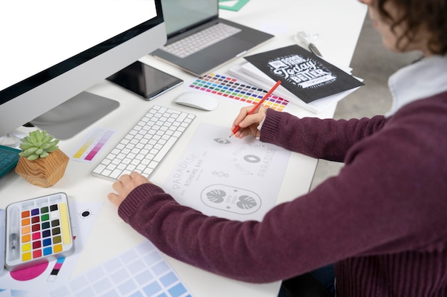 Graphic designer making a logo on a notebook