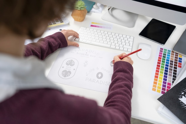 Graphic designer making a logo on a notebook