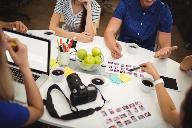 Graphic designers having discussion in office