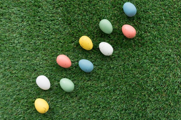 Grass background with easter eggs in different colors