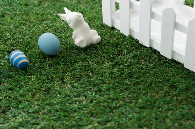 Grass background with rabbit and easter eggs