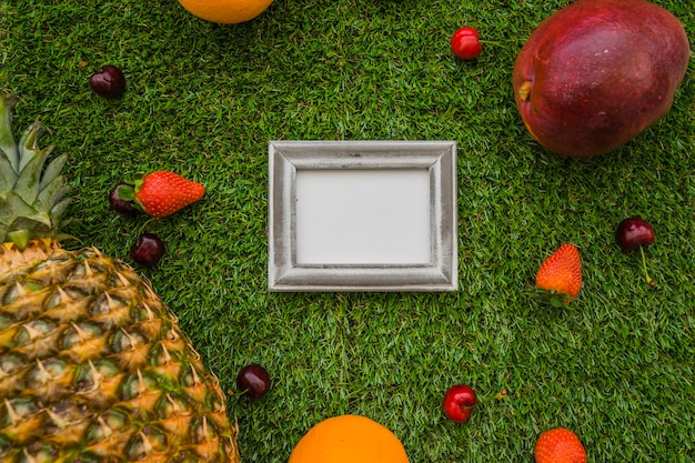 Grass surface with fruits and frame