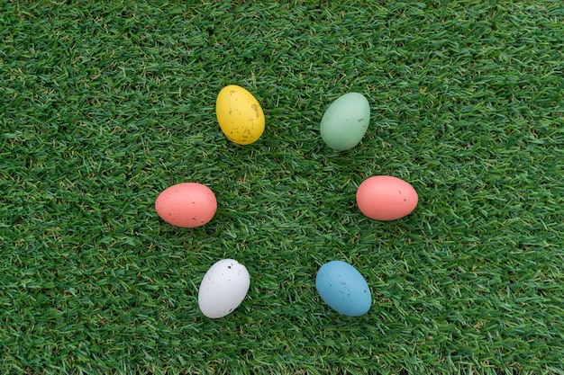 Grass surface with six colored eggs for easter day