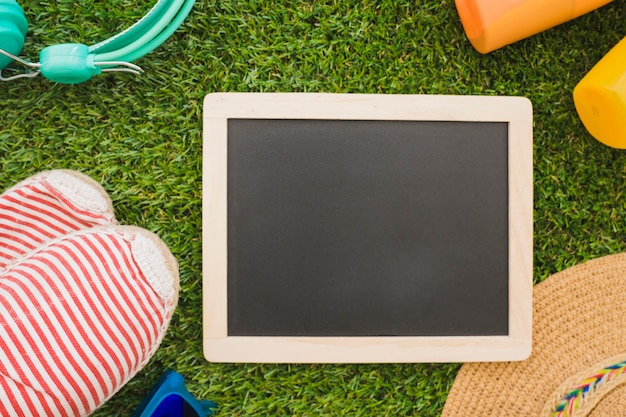 Grass surface with summer elements and blank slate