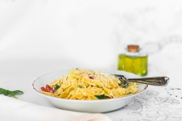 Grated cheese on the farfalle pasta in plate