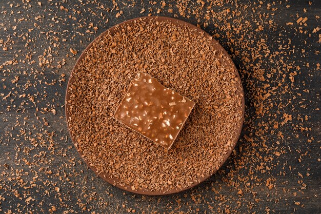 Grated chocolate with choco bar in a plate