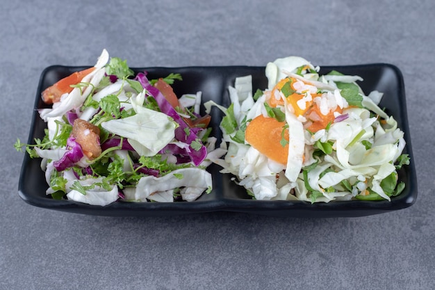 Grated vegetables in the bowl , on the marble surface.