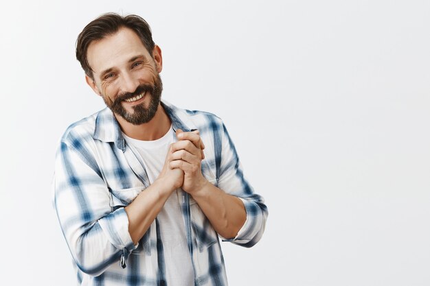 Grateful bearded mature man posing