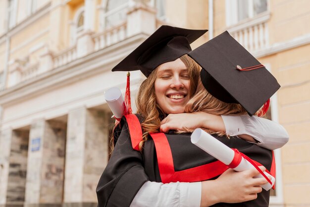 Gratuated girls hugging