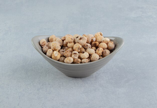 A gray bowl full of delicious dried fruit .