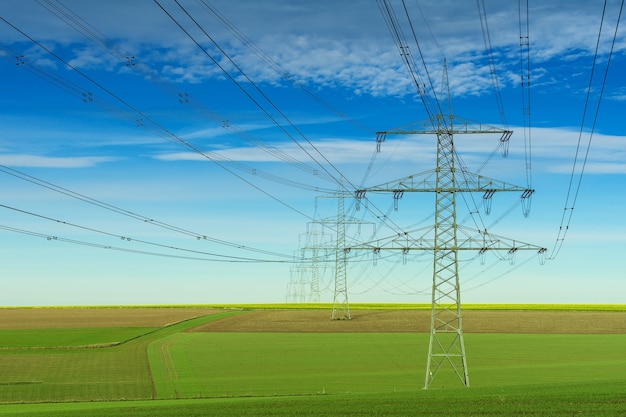 Gray electric post under white and blue cloudy sky