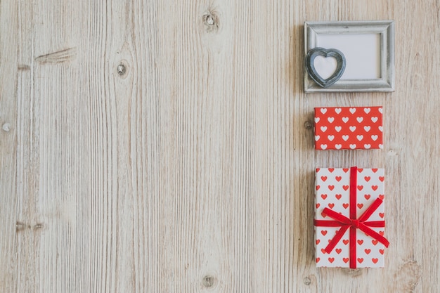 Gray frame and polka dot gifts on a wooden table