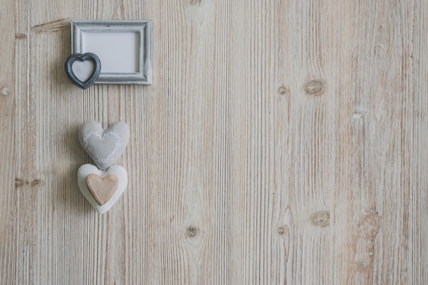 Gray photo frame with three hearts underneath