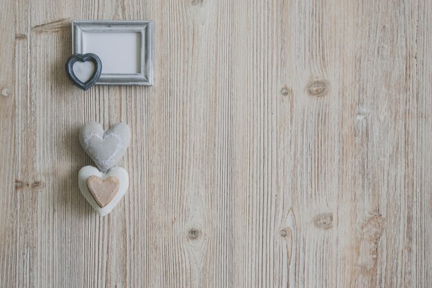 Gray photo frame with three hearts underneath