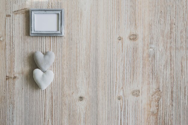 Gray photo frame with two hearts underneath