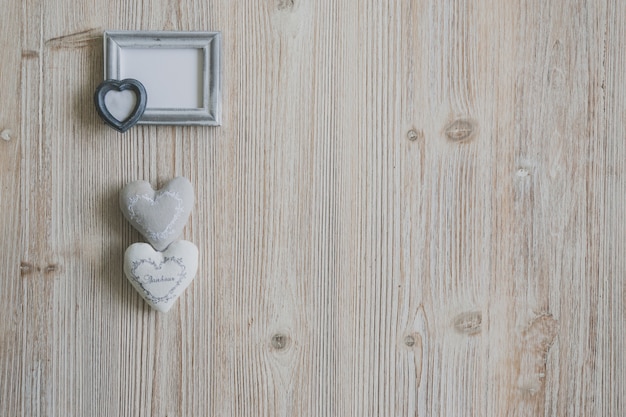 Gray photo frame with two hearts underneath