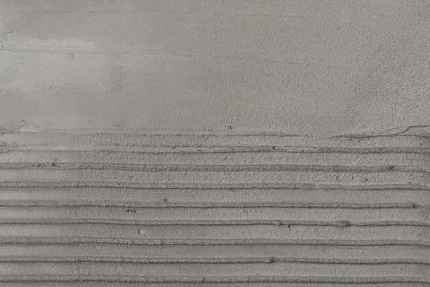 灰色の縞模様のコンクリートの織り目加工の背景