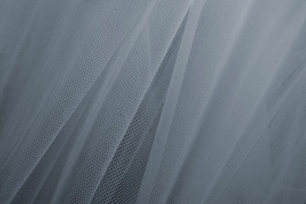 灰色のチュールのカーテンの織り目加工の背景