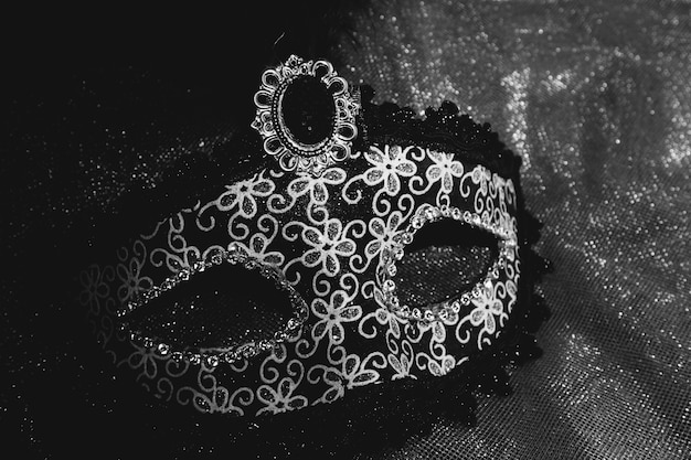 Free photo gray venetian mask on a dark background