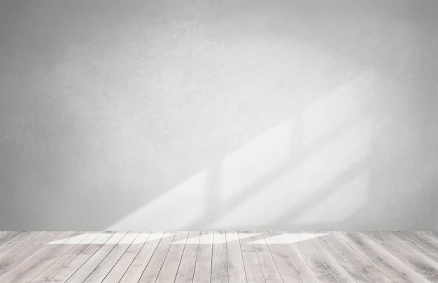 Gray wall in an empty room with a wooden floor