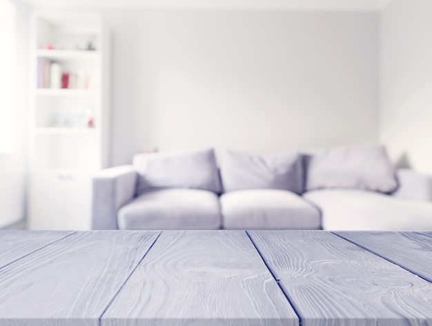 Gray wooden table in front of blur white sofa in the living room