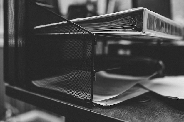 Free photo grayscale closeup shot of folders and papers