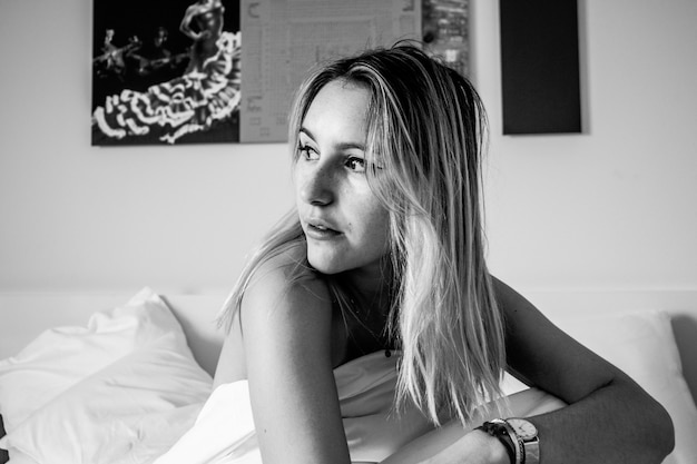 Grayscale photography of woman inside room