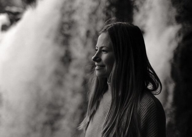 Grayscale shot of a charming Caucasian female looking aside