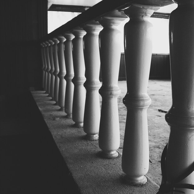 Grayscale shot of columns in a balustrade