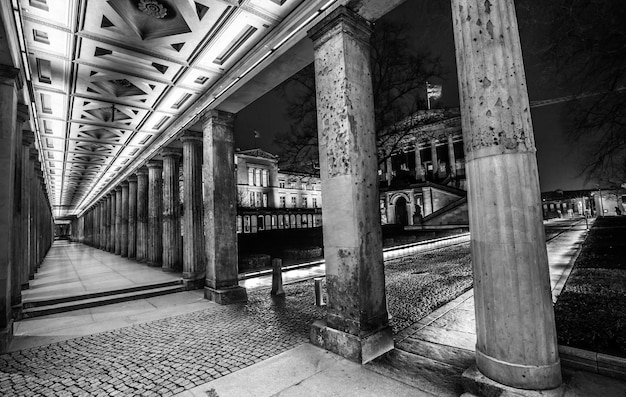 Grayscale shot of a hallway with pillars