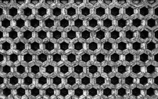 Grayscale shot of metal tubes stacked on each other