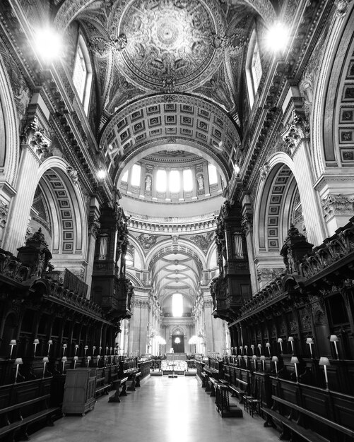 Grayscale shot of an old building interior surrounded by the lights