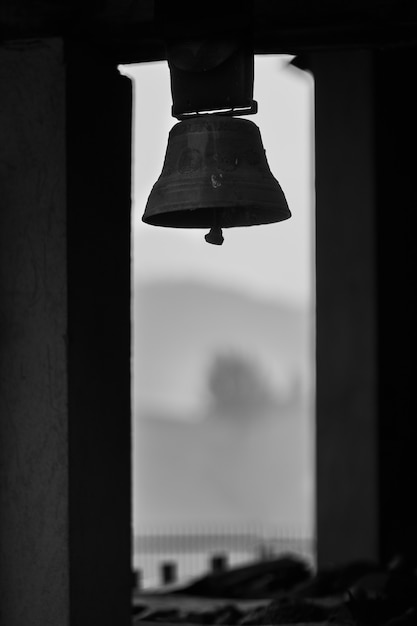 Grayscale shot of an old church bell