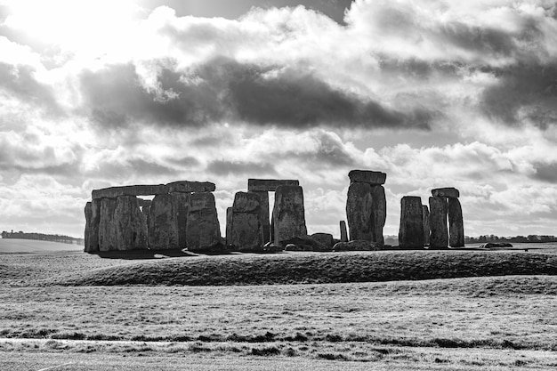 Grayscale shot of the Stonehenge in England under a cloudy sky