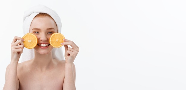 Great food for a healthy lifestyle beautiful young shirtless woman holding piece of orange standing