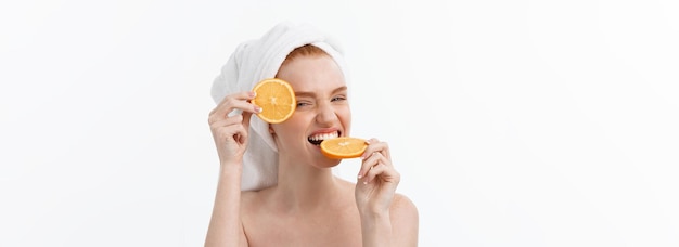 Great food for a healthy lifestyle beautiful young shirtless woman holding piece of orange standing