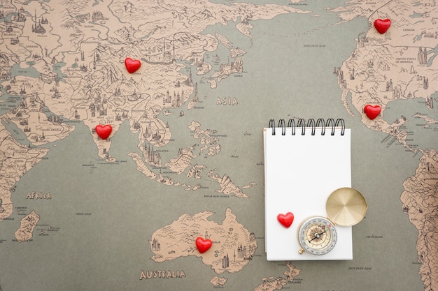 Great travel background with vintage world map, notebook and compass