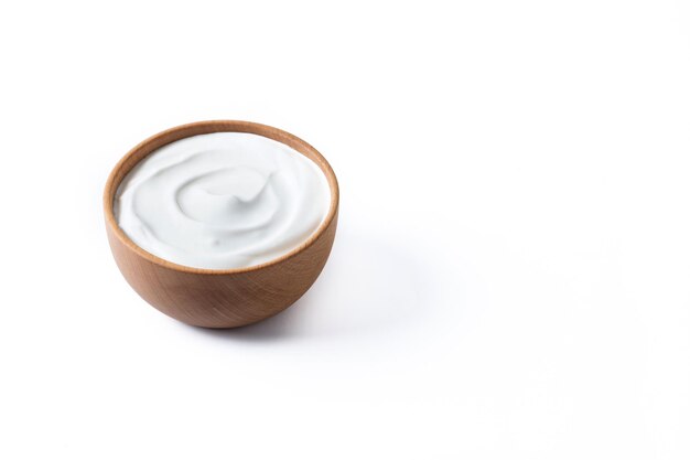 Greek yogurt in wooden bowl isolated on white background Creamy natural yogurt