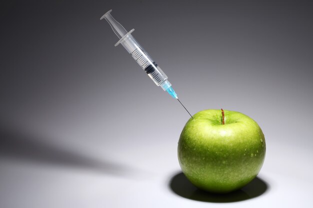 Green apple and syringe