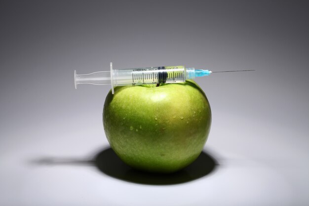 Green apple and syringe