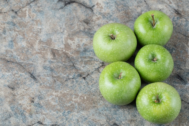 Green apples isolated on a concrete surface