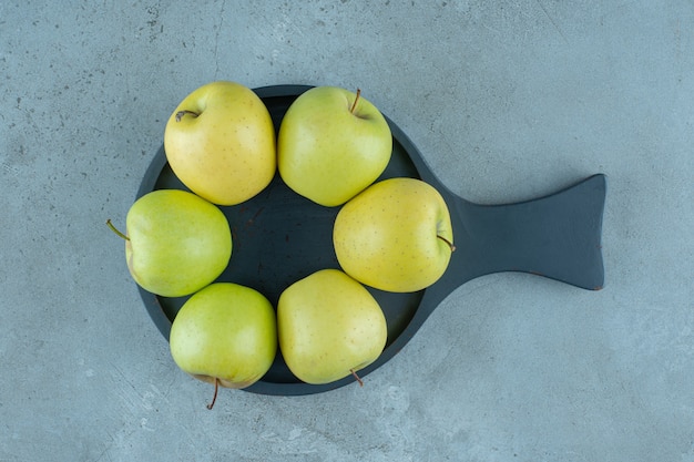 Green apples on a pan , on the marble background. High quality photo