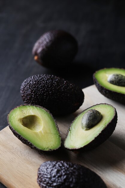 Green avocados on cutting board