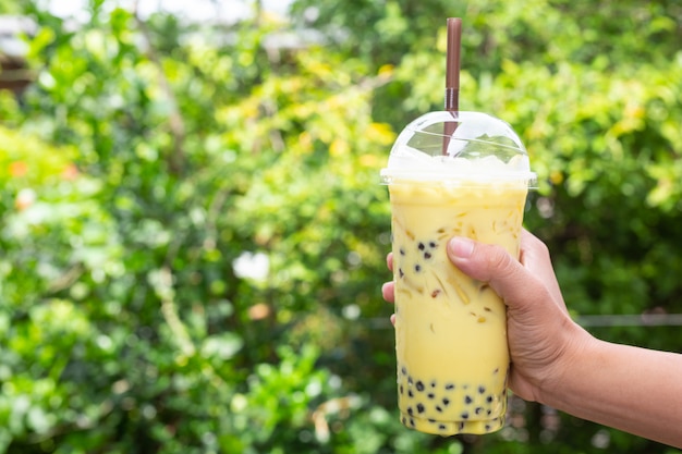 Green background, green tea and bokeh trees.