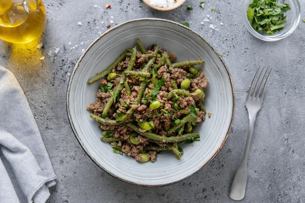 Green beans with minced meat in bowl