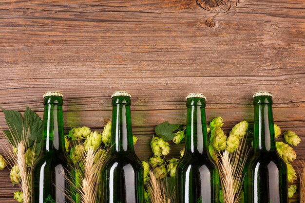 Green beer bottles on wooden background