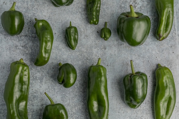 Green bell peppers on gray ground