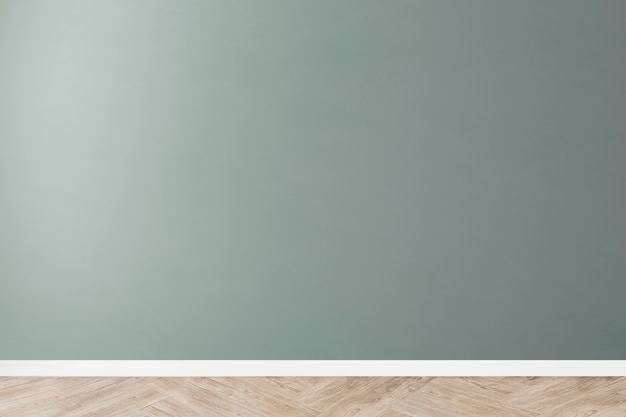 Green blank concrete wall mockup with a wooden floor